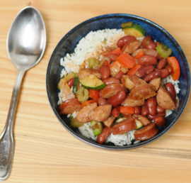 A bowl of red beans and rice with andouille sausage