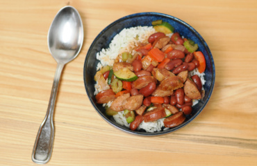 A bowl of red beans and rice with andouille sausage