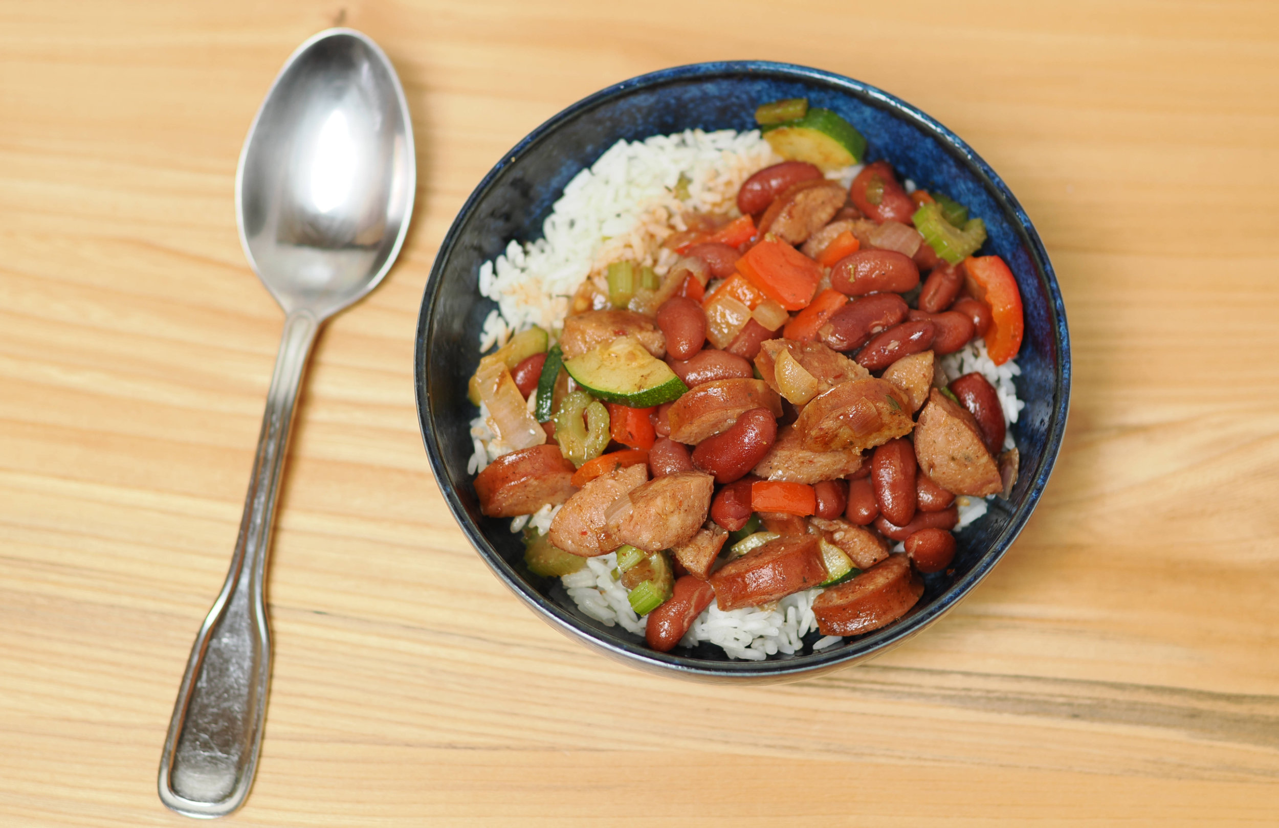 A bowl of red beans and rice with andouille sausage